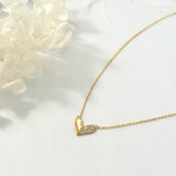 Sasha Love Heart Half Pavé Necklace in 18K gold-plated sterling silver, featuring a delicate heart charm with half pavé crystal detailing—elegant, hypoallergenic, and perfect for layering
