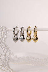 Gold hoop earrings featuring dainty heart-shaped charms, crafted in 18K gold-plated sterling silver—elegant, lightweight, and perfect for everyday sparkle or romantic layering.