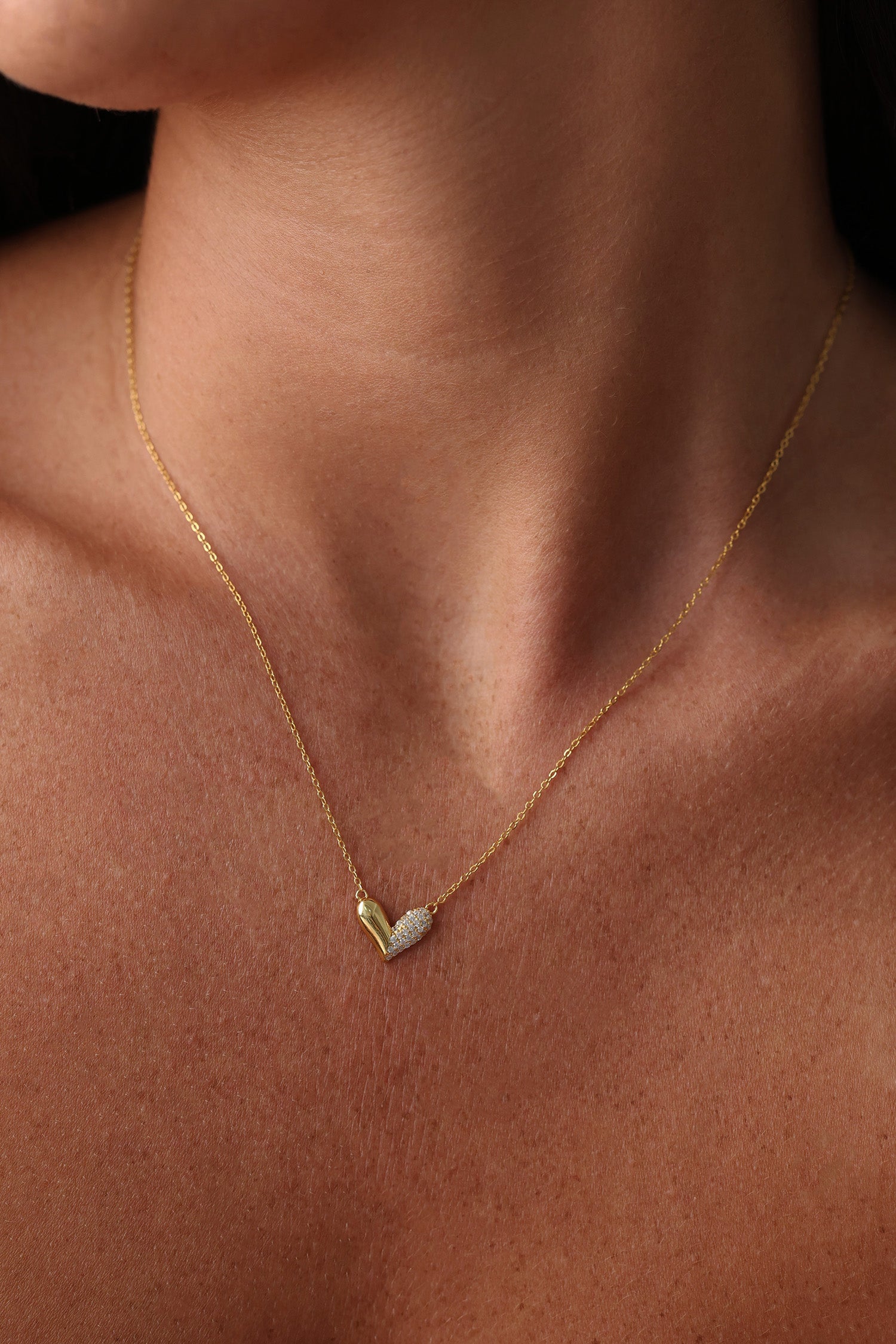 Sasha Love Heart Half Pavé Necklace in 18K gold-plated sterling silver, featuring a delicate heart charm with half pavé crystal detailing—elegant, hypoallergenic, and perfect for layering
