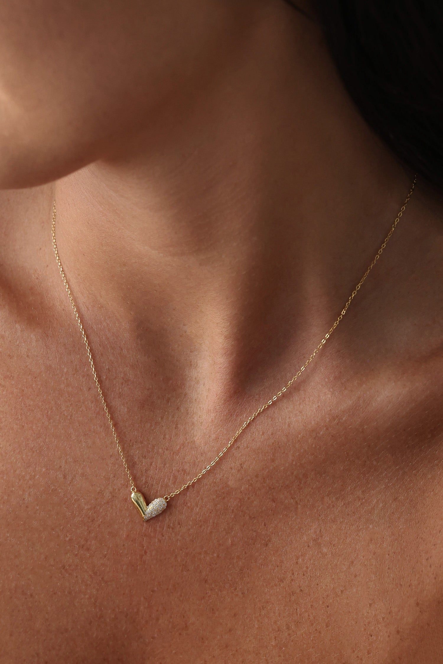 Sasha Love Heart Half Pavé Necklace in 18K gold-plated sterling silver, featuring a delicate heart charm with half pavé crystal detailing—elegant, hypoallergenic, and perfect for layering