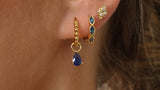 Gold ear stack with blue marquise huggie hoops and a blue pear drop charm