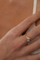Elodie toi et moi pear ring in gold worn on a model's finger, close view