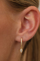 Model wearing the Sara gold marquise drop huggie, side profile