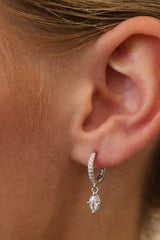 Model wearing the Sara marquise drop huggie in sterling silver, side view