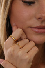 Delphine star eternity band worn beside a vintage cluster ring in gold