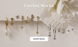 Earring stack collection with gold and silver huggies, studs, CZ designs and a pearl drop earring.