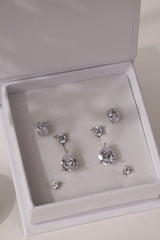 Full silver Adamas set in a white ANETT gift box — oval studs, round studs and pear drop ear jackets.