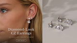 Close-up of a model's ear wearing silver diamond-look CZ pear drop ear jacket earrings with two studs. The Sparkle Edit — 20% off sitewide, Shop the Sparkle Edit.