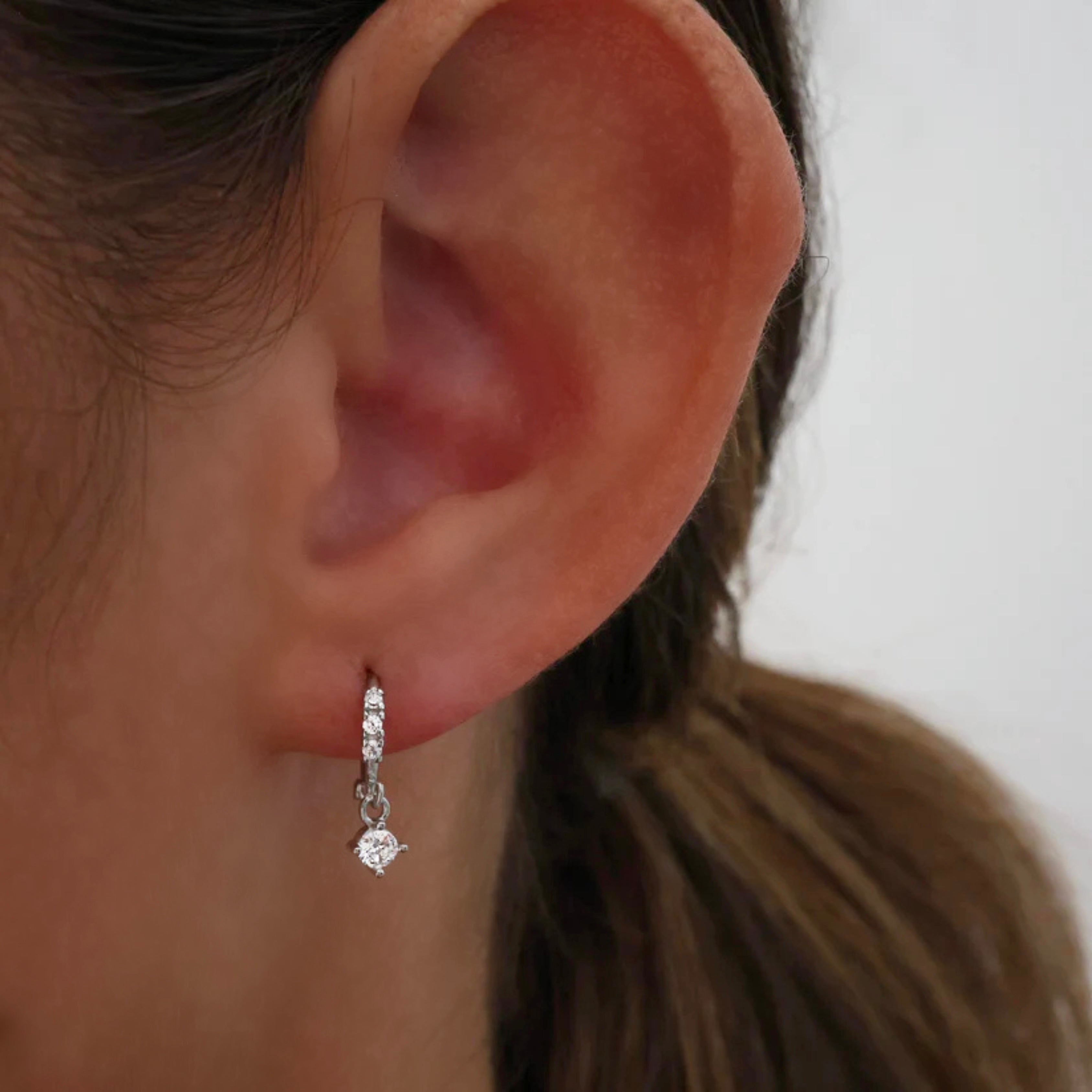 Dainty cubic zirconia dangle earrings in a delicate gold design