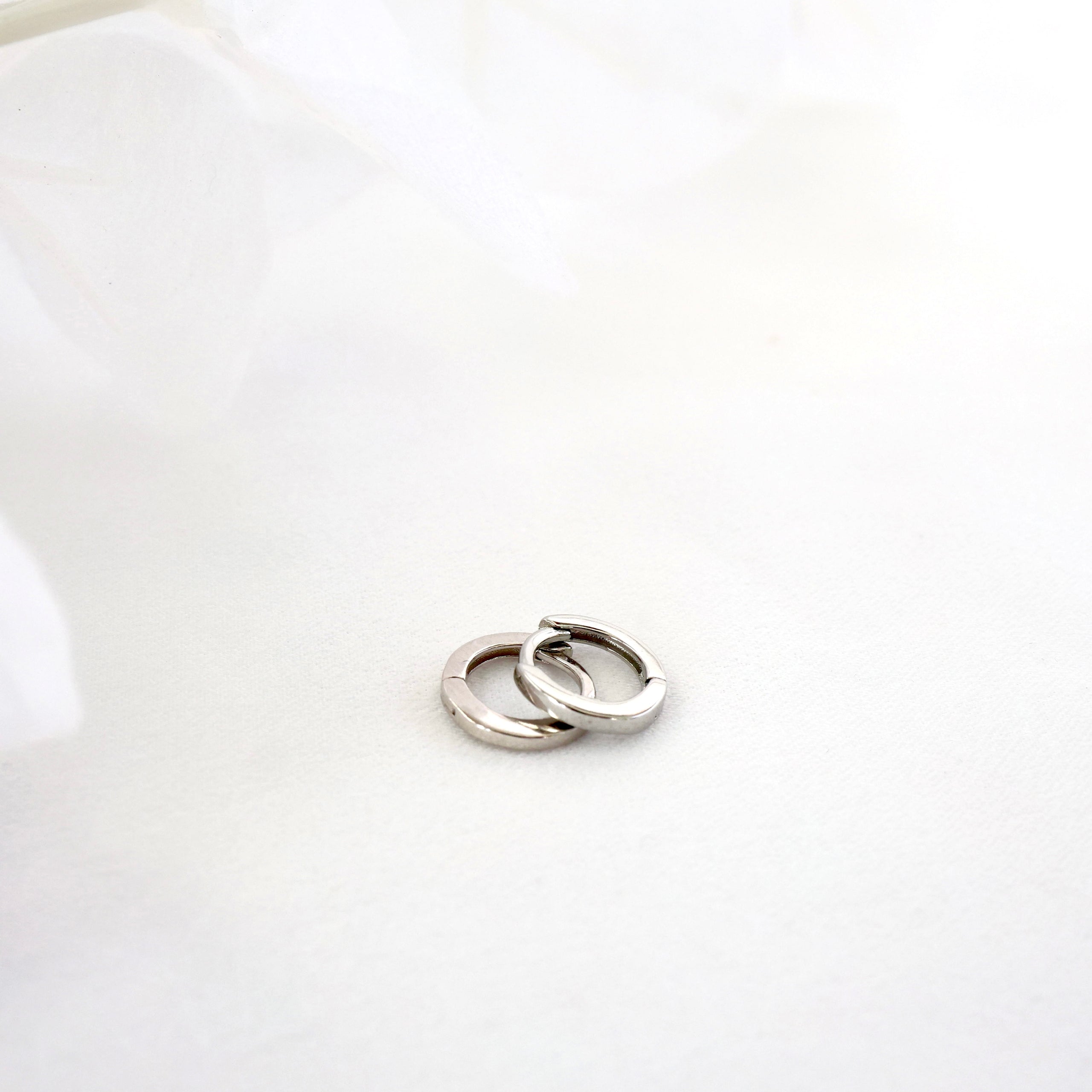 Suni Everyday Stacking Earrings in sterling silver—lightweight huggies and clover studs for effortless layering, hypoallergenic and shimmer-ready