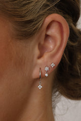 Small silver clover earring set with dangle, snowflake stud, and mini clover stud displayed on a clean background.”