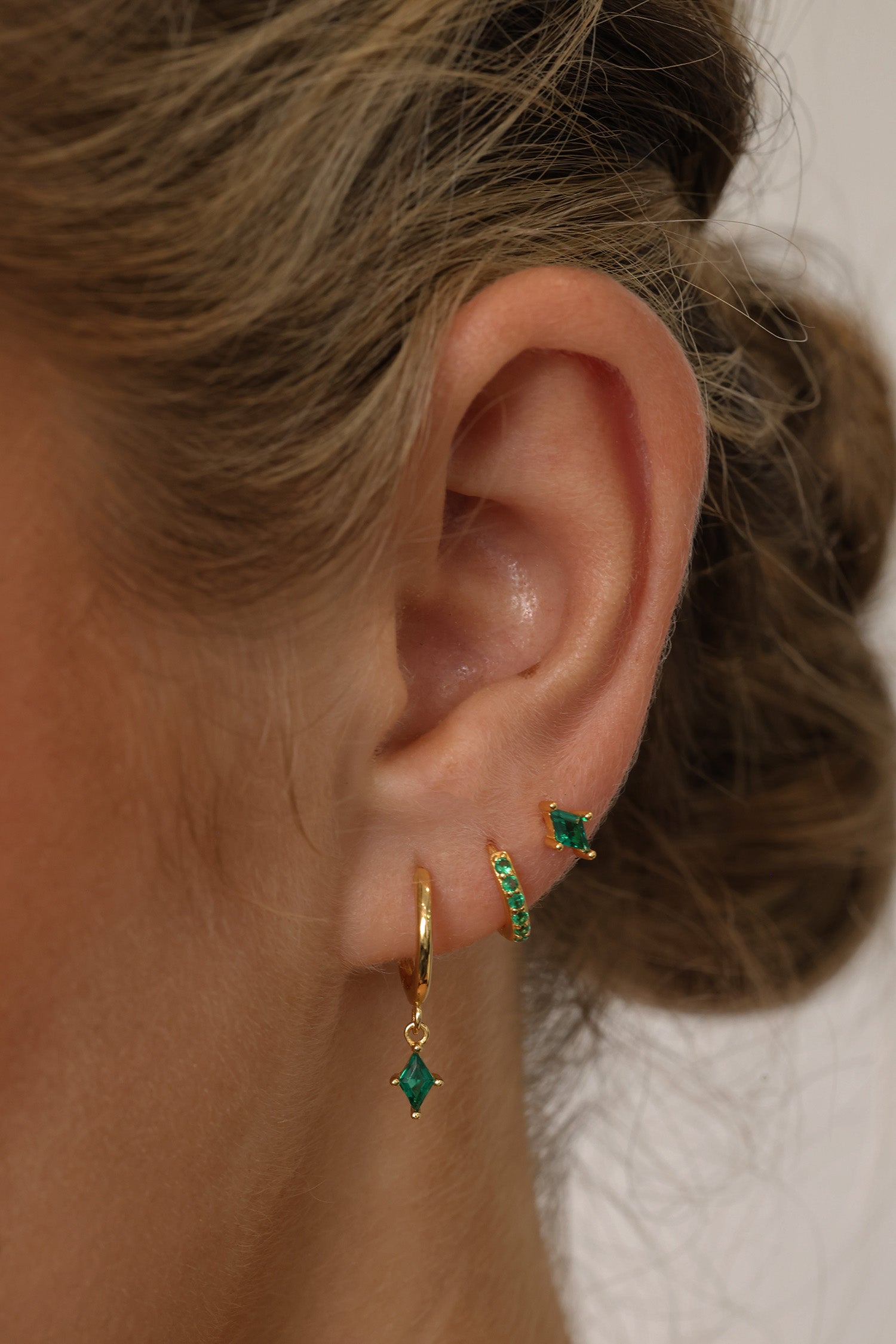 Emerald green cubic zirconia dangle drop earring set featuring brilliant faceted stones that sparkle from every angle. Includes three coordinating pieces that can be worn together or individually for an elegant, sophisticated look.