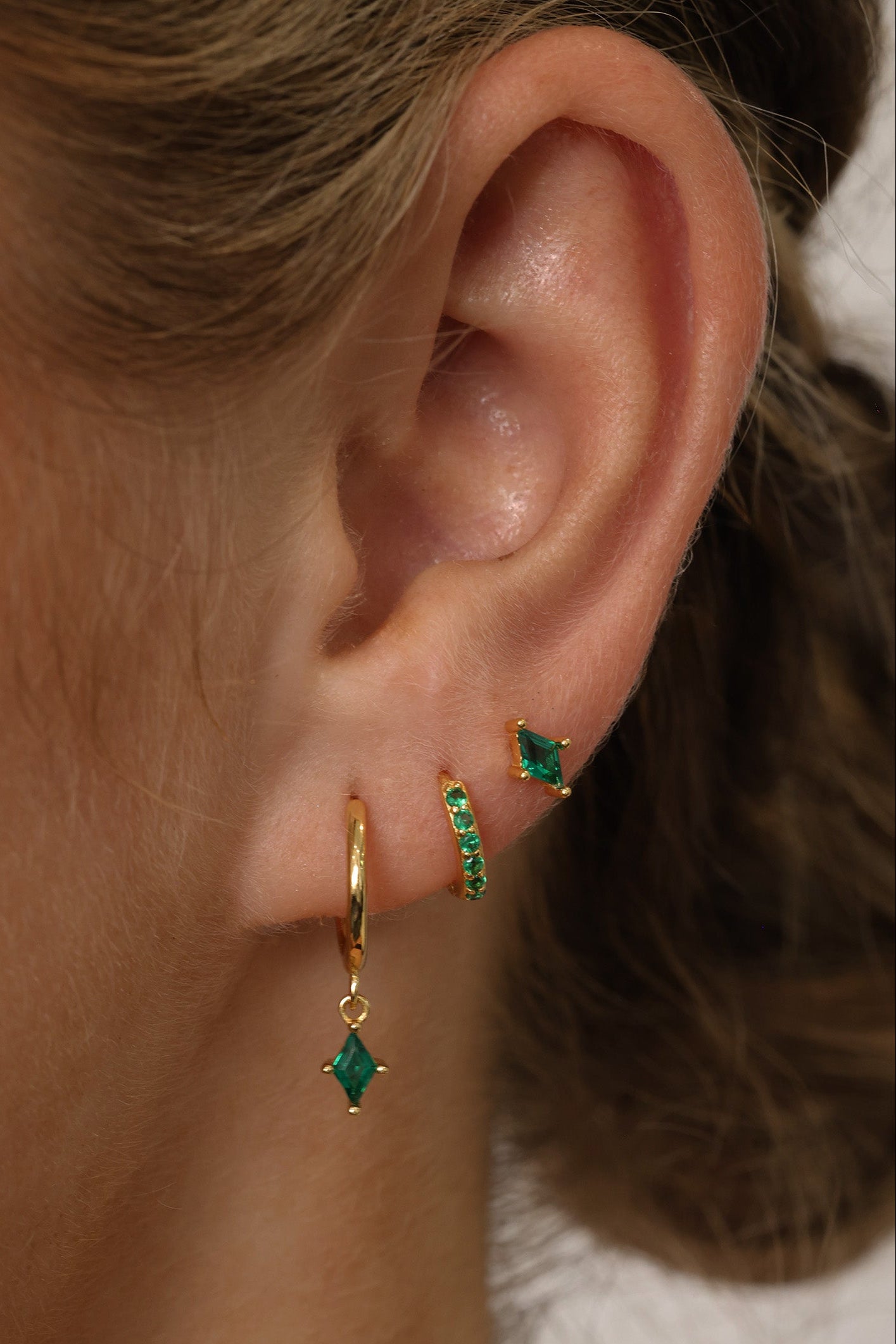 Emerald green cubic zirconia dangle drop earring set featuring brilliant faceted stones that sparkle from every angle. Includes three coordinating pieces that can be worn together or individually for an elegant, sophisticated look.