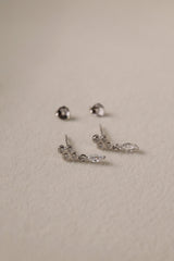 A delicate pair of dangle stud earrings with a refined, light‑catching drop. Crafted in rhodium‑plated 925 sterling silver with premium AAAAA cubic zirconia, they offer timeless sparkle for everyday wear or special occasions.