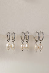 Waterproof pavé hoop earrings with natural freshwater pearl drops. Available in 10mm, 12mm, and 14mm. Tarnish‑resistant, elegant, and perfect for everyday wear.