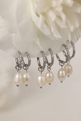 Waterproof pavé hoop earrings with natural freshwater pearl drops. Available in 10mm, 12mm, and 14mm. Tarnish‑resistant, elegant, and perfect for everyday wear.