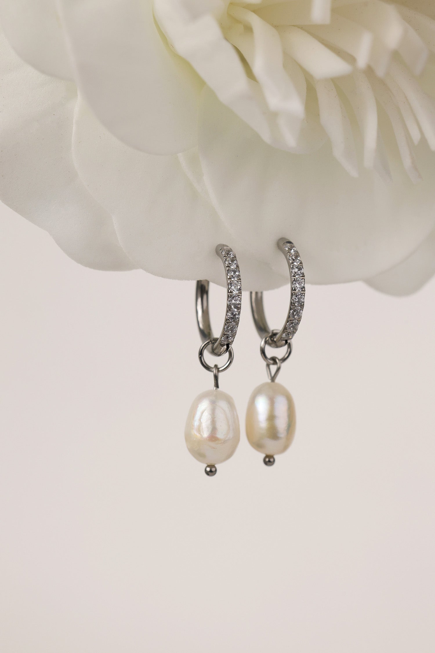 Waterproof pavé hoop earrings with natural freshwater pearl drops. Available in 10mm, 12mm, and 14mm. Tarnish‑resistant, elegant, and perfect for everyday wear.