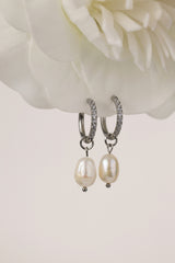 Waterproof pavé hoop earrings with natural freshwater pearl drops. Available in 10mm, 12mm, and 14mm. Tarnish‑resistant, elegant, and perfect for everyday wear.