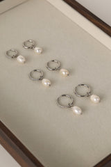 Waterproof pavé hoop earrings with natural freshwater pearl drops. Available in 10mm, 12mm, and 14mm. Tarnish‑resistant, elegant, and perfect for everyday wear.