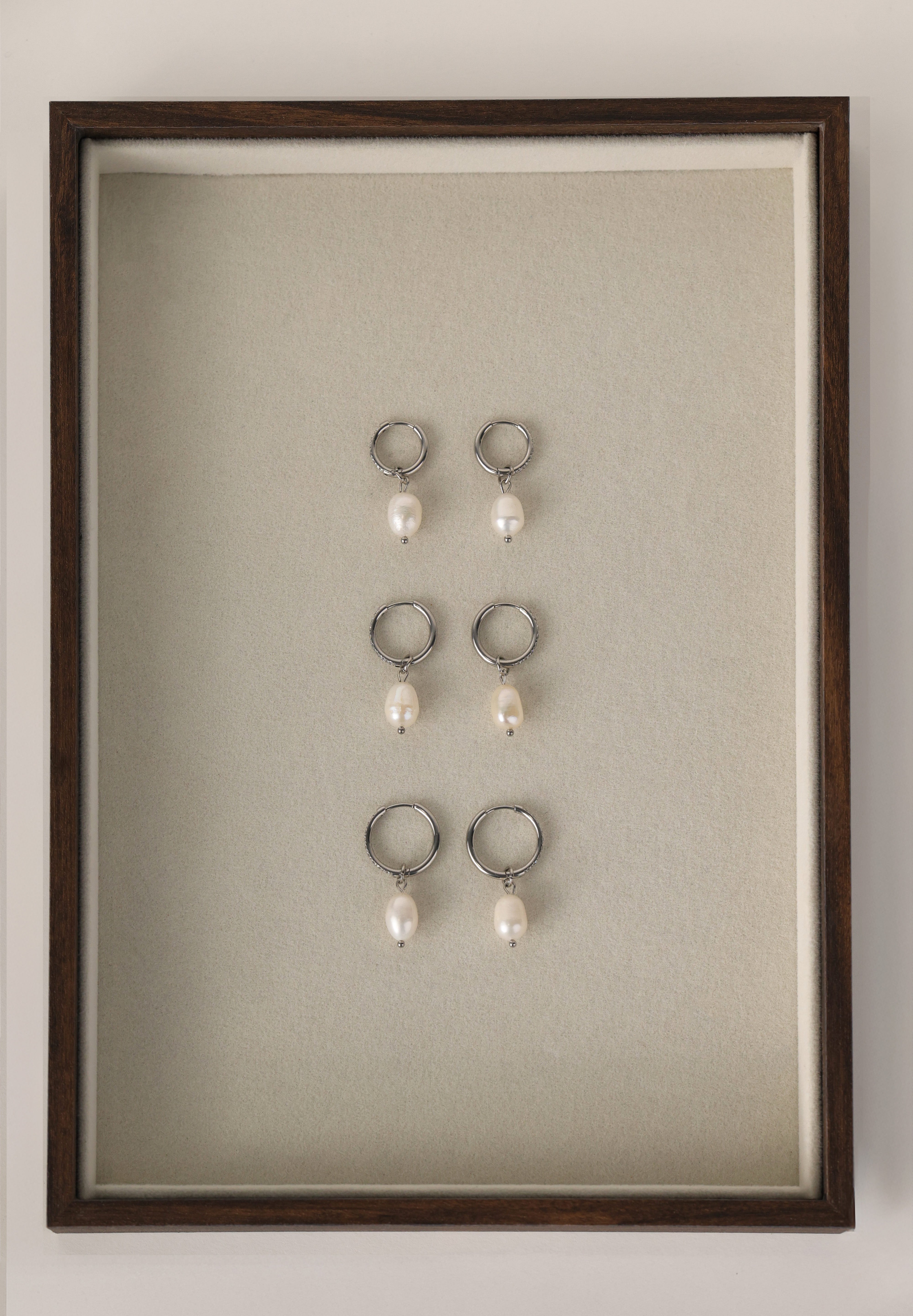 Waterproof pavé hoop earrings with natural freshwater pearl drops. Available in 10mm, 12mm, and 14mm. Tarnish‑resistant, elegant, and perfect for everyday wear.
