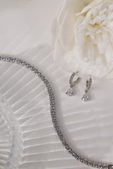 Silver Lanette tennis bracelet shown with silver diamond drop earrings.