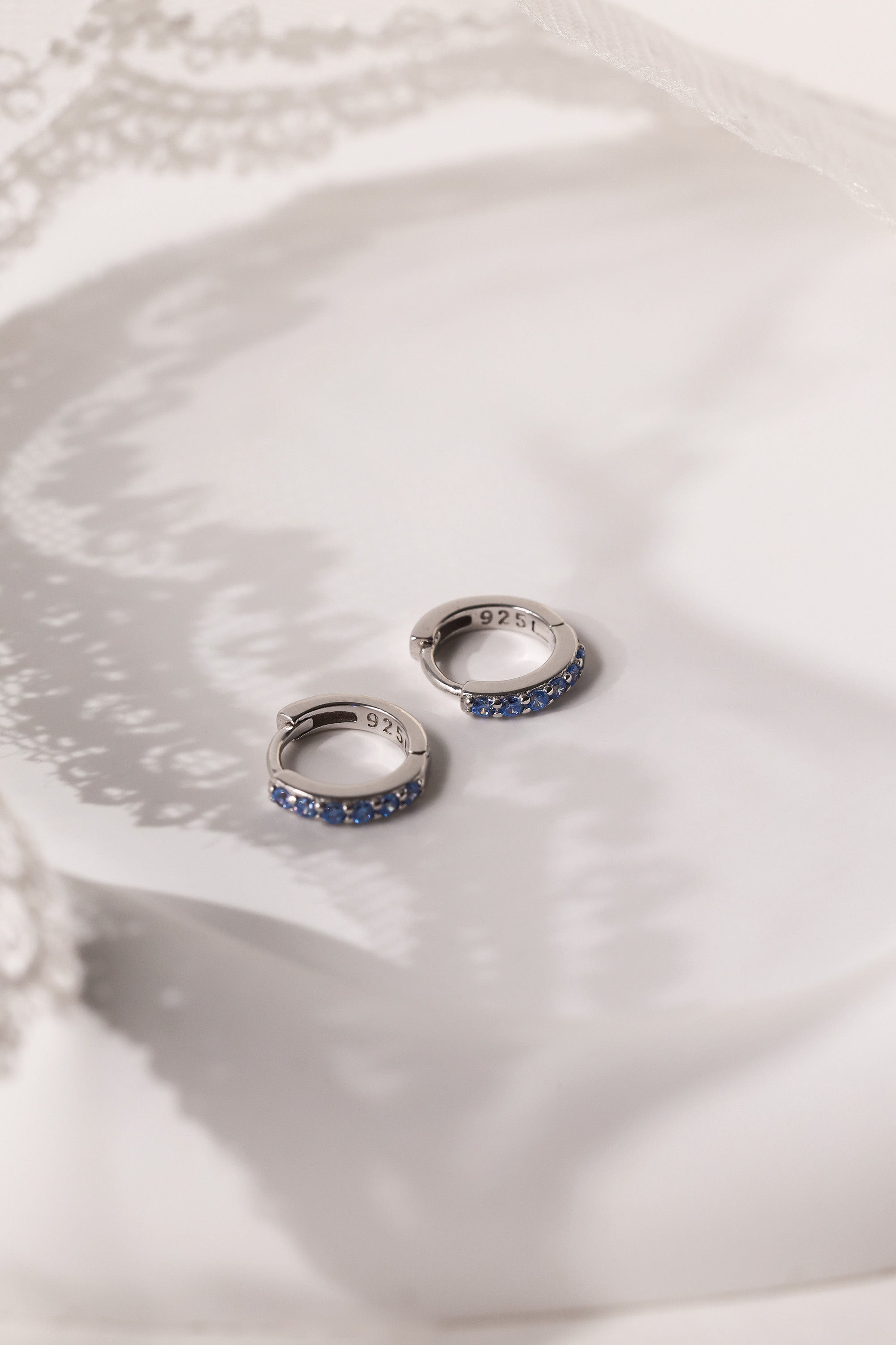 Mia Blue Huggie Dangle Earrings in Sterling Silver – rhodium-plated hoops with blue cubic zirconia, hypoallergenic dainty silver earrings for women, available individually or as part of 3-pair earring stack set