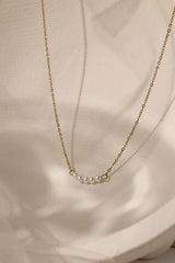 Veloura Pearl Necklace in stainless steel—five dainty pearls floating on a shimmer-ready chain, waterproof and giftable for everyday glow