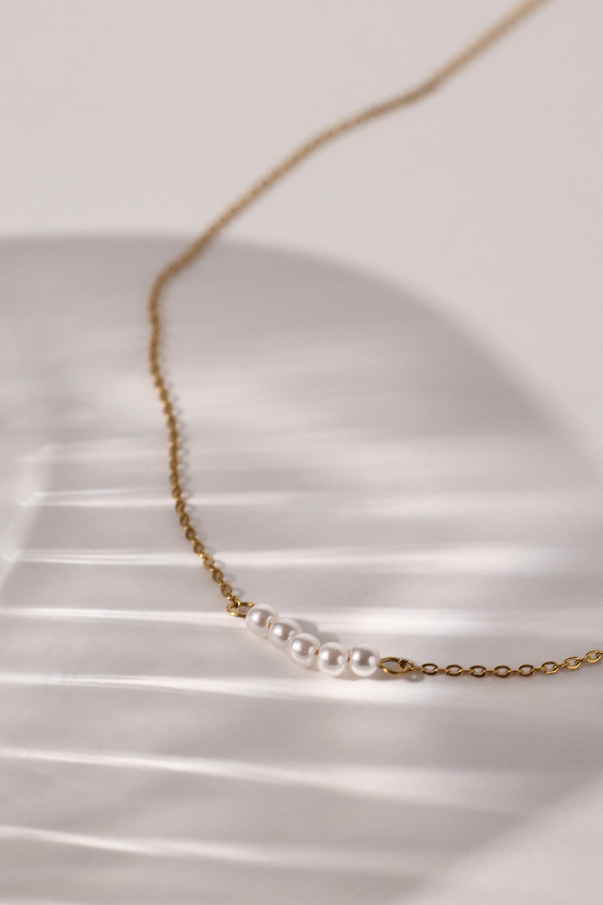 Veloura Pearl Necklace in stainless steel—five dainty pearls floating on a shimmer-ready chain, waterproof and giftable for everyday glow