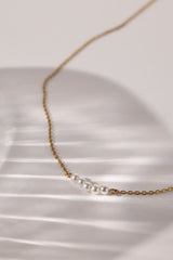Veloura Pearl Necklace in stainless steel—five dainty pearls floating on a shimmer-ready chain, waterproof and giftable for everyday glow