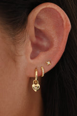 Gold hoop earrings featuring dainty heart-shaped charms, crafted in 18K gold-plated sterling silver—elegant, lightweight, and perfect for everyday sparkle or romantic layering.