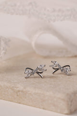 Silver stud earrings with tied ribbon detailing, 13mm wide by 7.5mm high, elegant for daily or special wear