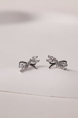 Silver stud earrings with tied ribbon detailing, 13mm wide by 7.5mm high, elegant for daily or special wear