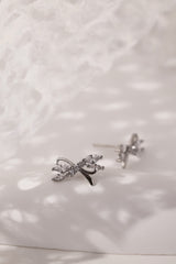 Silver stud earrings with tied ribbon detailing, 13mm wide by 7.5mm high, elegant for daily or special wear