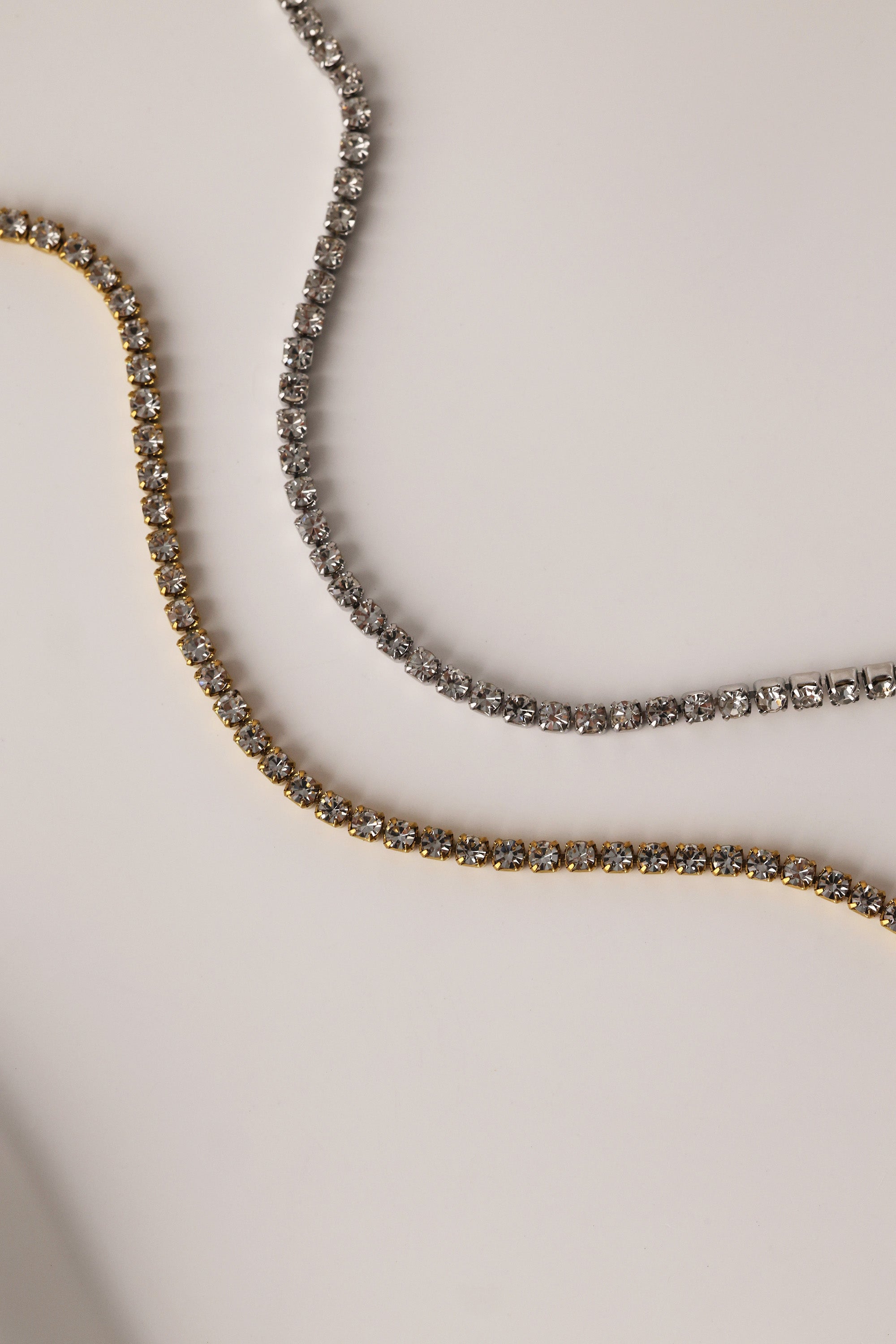 Skinny 2.5mm stainless steel tennis necklace with sparkling stones, waterproof design, casual yet elegant, paired with matching bracelet.