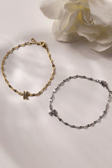 Dainty 18K gold-plated stainless steel bracelet with a single personalised initial charm, symbolising elegance and meaningful style.