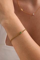 Dainty 18k gold-plated stainless steel birthstone bracelet with a single bezel-set gemstone, symbolizing personal meaning and everyday elegance.