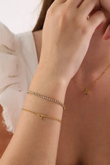 Skinny 2.5mm stainless steel tennis bracelet with sparkling stones, waterproof design, casual yet elegant, paired with matching necklace.