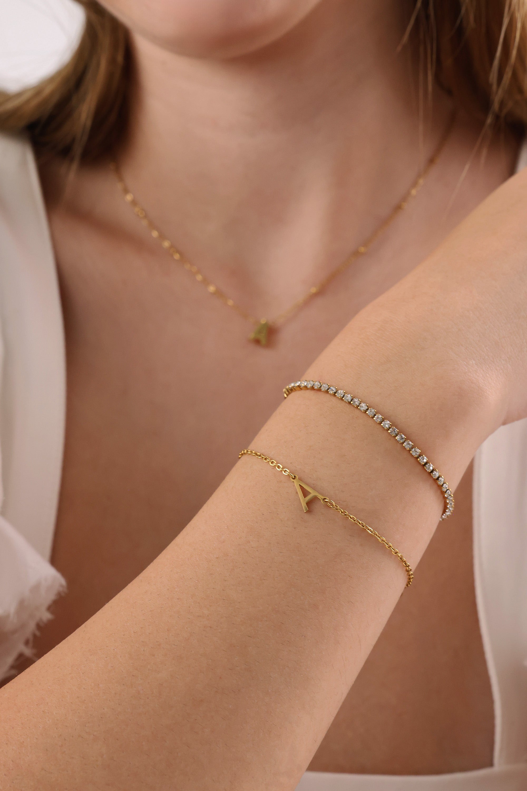 Skinny 2.5mm stainless steel tennis bracelet with sparkling stones, waterproof design, casual yet elegant, paired with matching necklace.