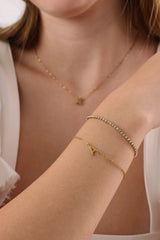 Skinny 2.5mm stainless steel tennis bracelet with sparkling stones, waterproof design, casual yet elegant, paired with matching necklace.