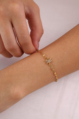 Dainty 18K gold-plated stainless steel bracelet with a single personalised initial charm, symbolising elegance and meaningful style.