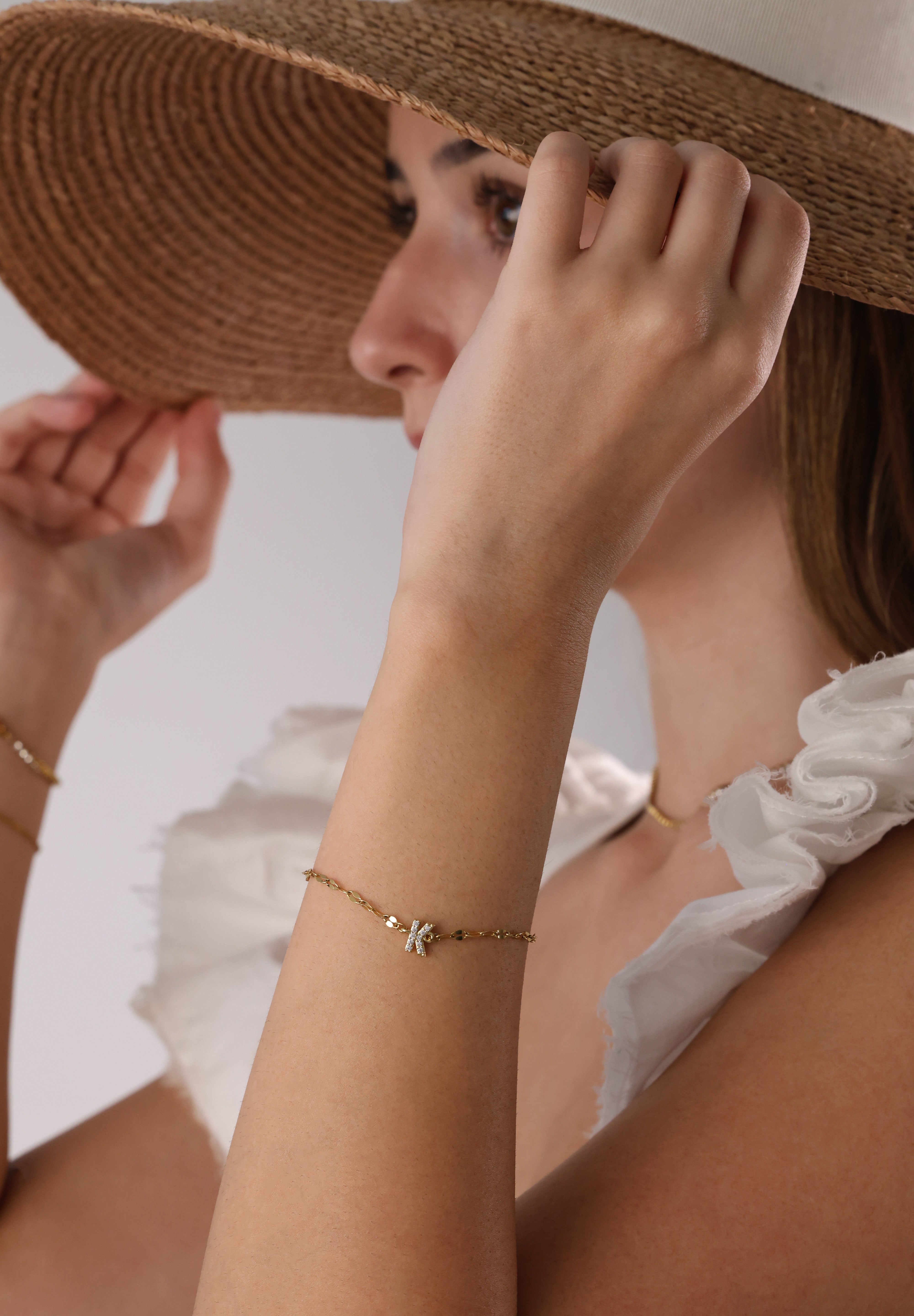 Dainty 18K gold-plated stainless steel bracelet with a single personalised initial charm, symbolising elegance and meaningful style.