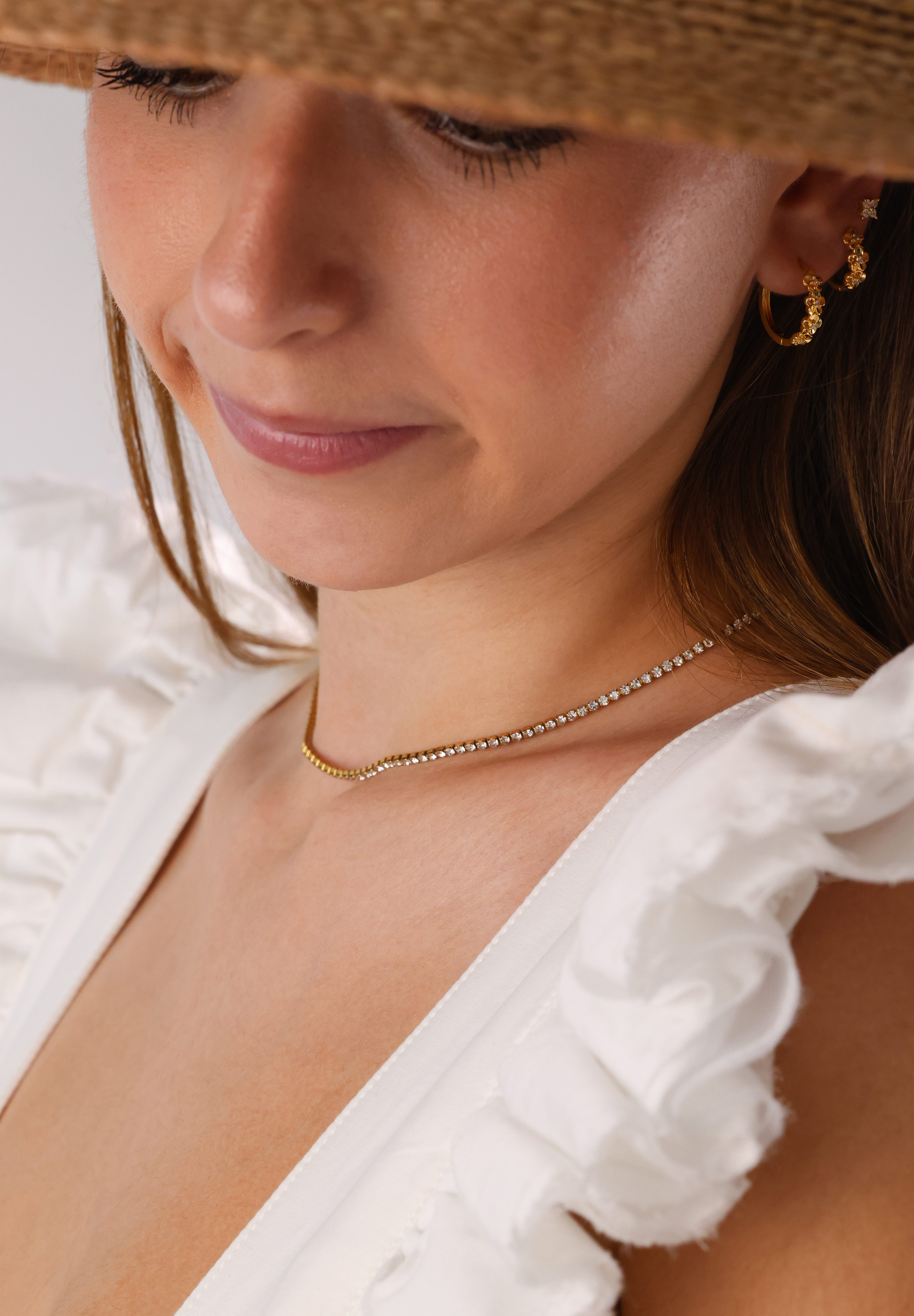 Skinny 2.5mm stainless steel tennis necklace with sparkling stones, waterproof design, casual yet elegant, paired with matching bracelet.