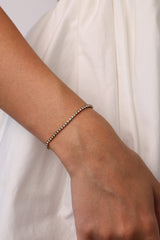 Skinny 2.5mm stainless steel tennis bracelet with sparkling stones, waterproof design, casual yet elegant, paired with matching necklace.