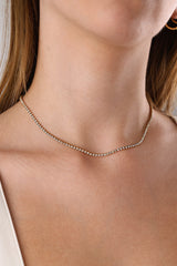 Skinny 2.5mm stainless steel tennis necklace with sparkling stones, waterproof design, casual yet elegant, paired with matching bracelet.