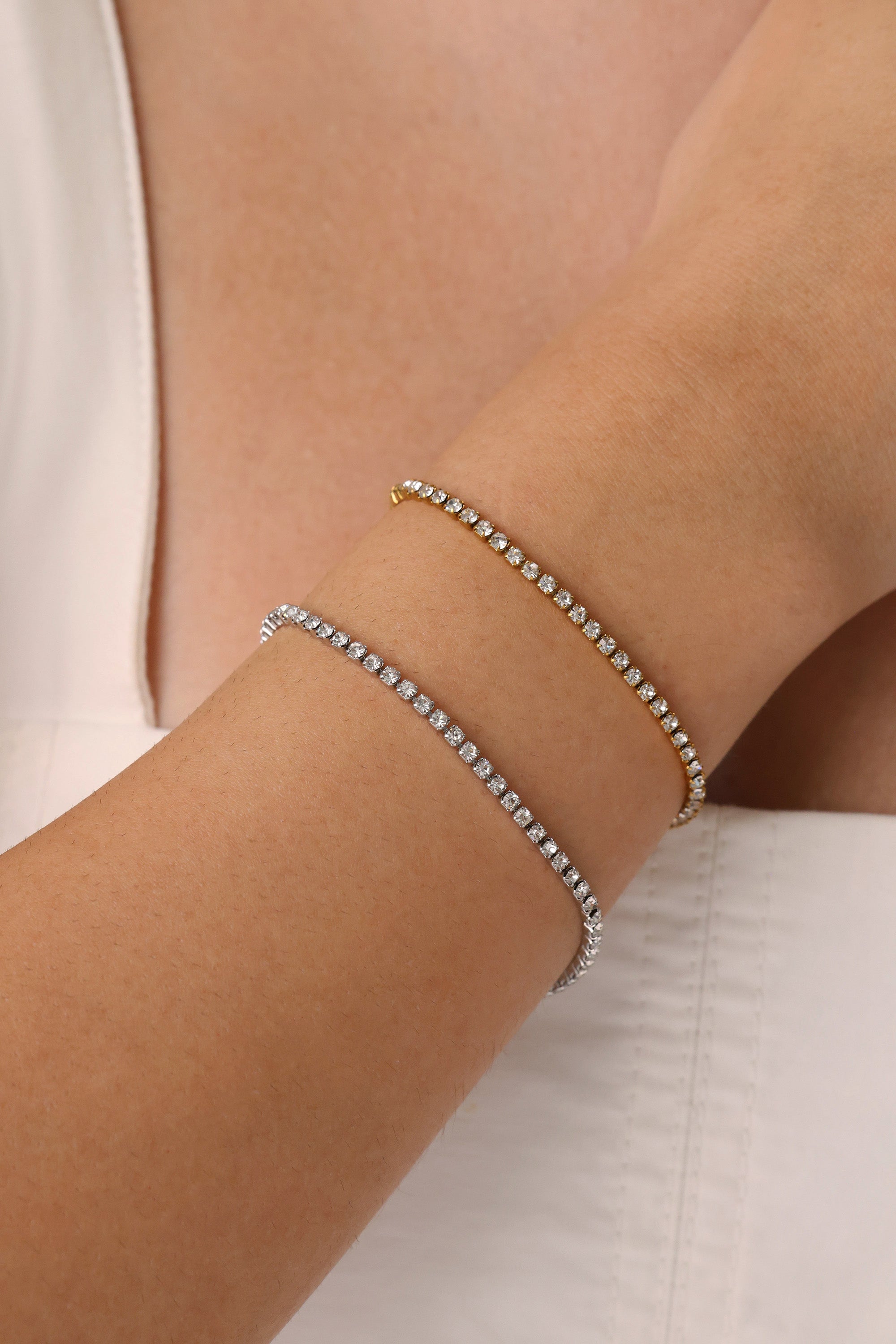 Skinny 2.5mm stainless steel tennis bracelet with sparkling stones, waterproof design, casual yet elegant, paired with matching necklace.