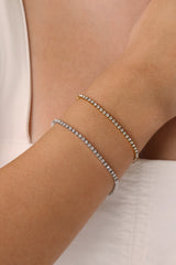 Skinny 2.5mm stainless steel tennis bracelet with sparkling stones, waterproof design, casual yet elegant, paired with matching necklace.