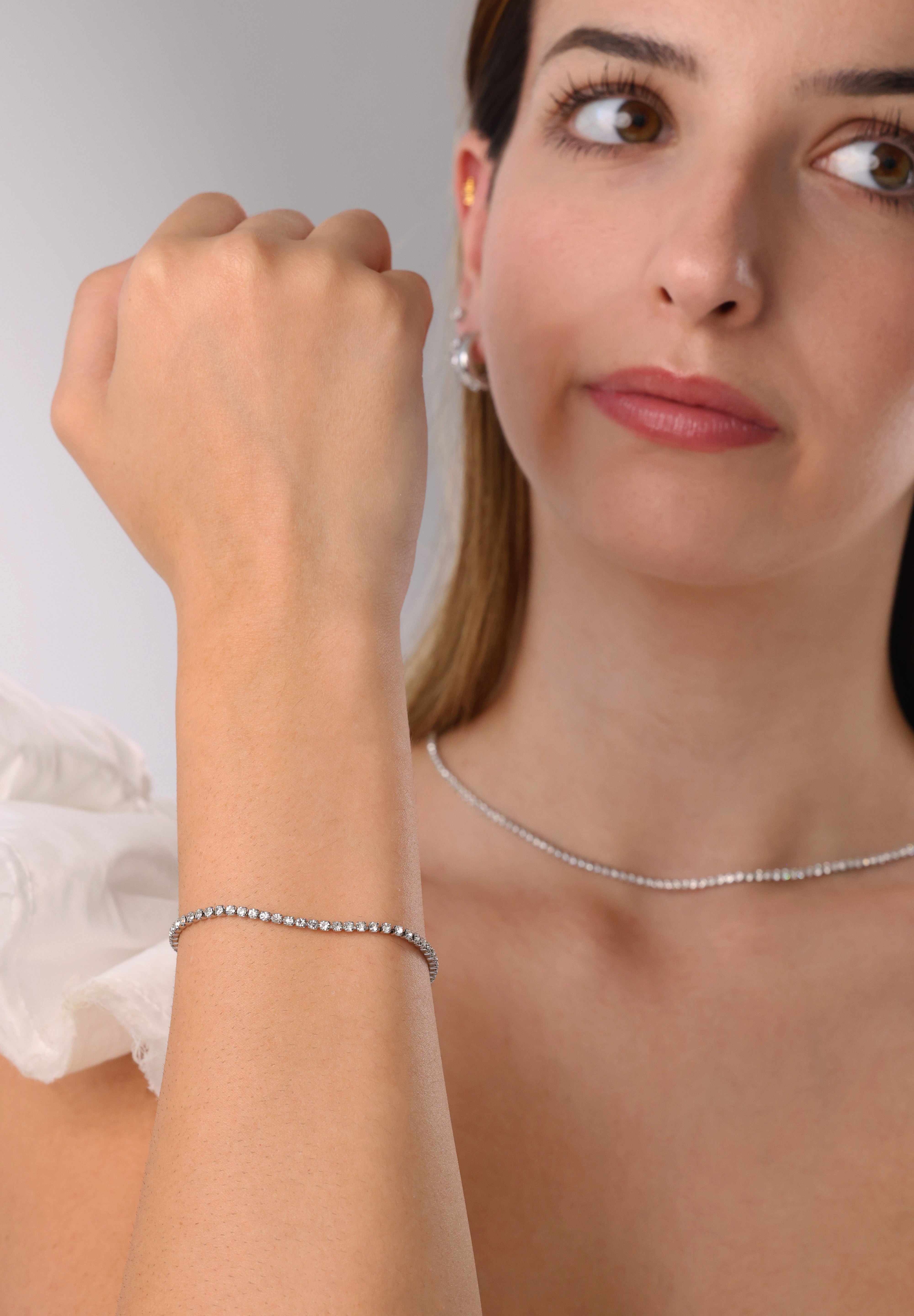 Skinny 2.5mm stainless steel tennis necklace with sparkling stones, waterproof design, casual yet elegant, paired with matching bracelet.