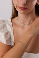 Skinny 2.5mm stainless steel tennis bracelet with sparkling stones, waterproof design, casual yet elegant, paired with matching necklace.