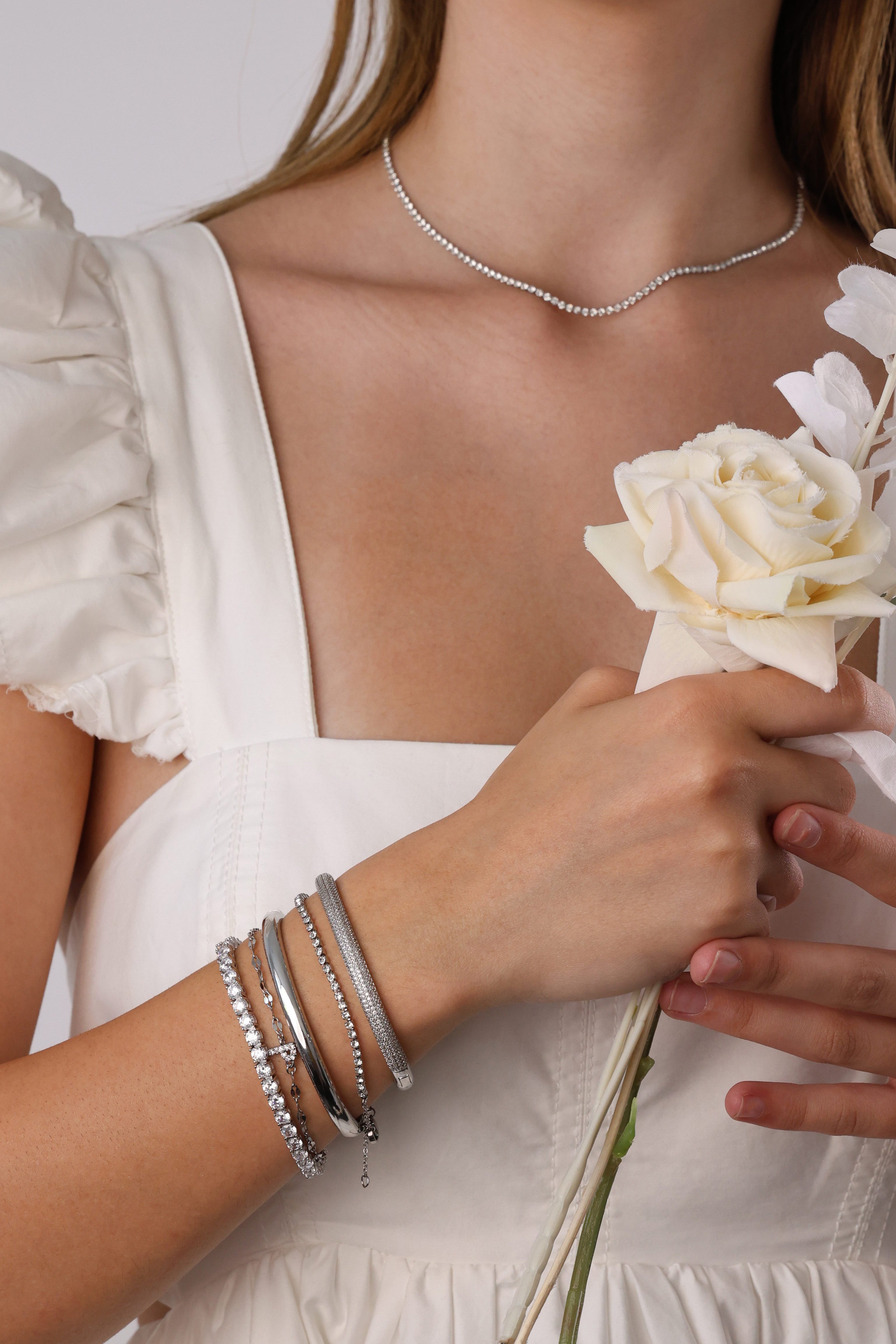 Skinny 2.5mm stainless steel tennis necklace with sparkling stones, waterproof design, casual yet elegant, paired with matching bracelet.