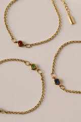 Dainty 18k gold-plated stainless steel birthstone bracelet with a single bezel-set gemstone, symbolizing personal meaning and everyday elegance.